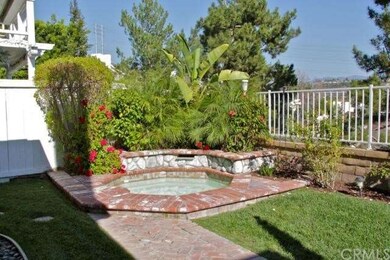 Sweet backyard with an in ground hot tub with bric