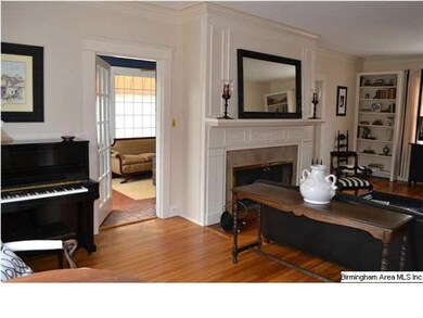 Off of living room is a cozy sunroom that might be