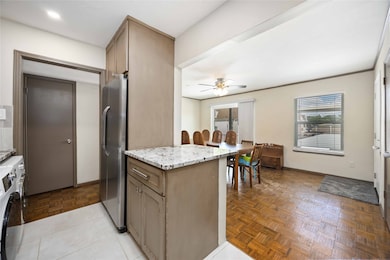 The dining room is open to the kitchen’s breakfast bar peninsula, it’s perfect for casual meals or entertaining guests.