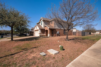 View of front facade with driveway, fence, roof w