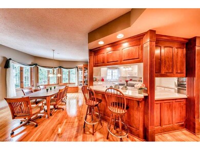 Kitchen has breakfast bar and spacious dinette wit
