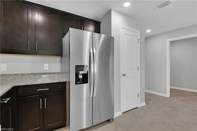 Kitchen with stainless steel refrigerator with ice