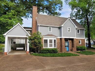 The home features an attached carport on the left 