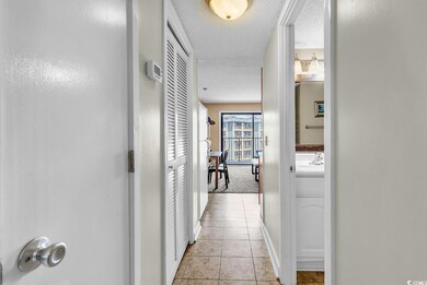 Corridor with light tile patterned flooring, a tex