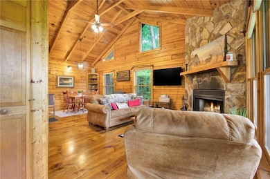 Living area featuring wooden walls, hardwood / woo