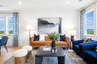 (Photo of decorated model, actual homes colors and finishes will vary) The spacious and open-concept main level allows for optimal versatility and comfort.