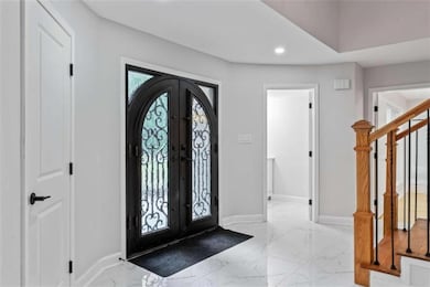Foyer with french doors, baseboards, recessed ligh