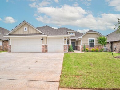 Craftsman-style home with a garage and a front law