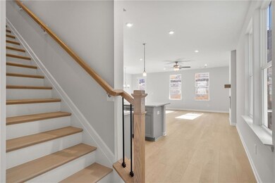 Stairway with hardwood / wood-style flooring and c