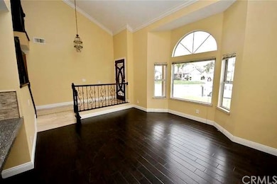 Hardwood floor, crown molding, wrought iron spindl
