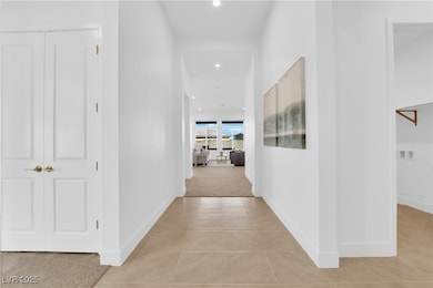 Corridor with light tile patterned flooring, light