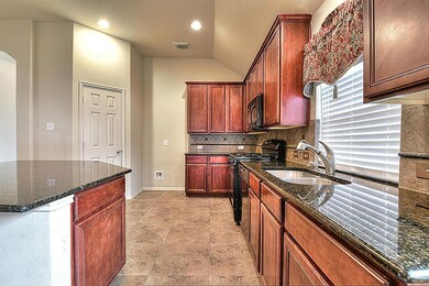 Large open kitchen with granite counter tops and tons of cabinets for storage space. Door leads into your pantry.