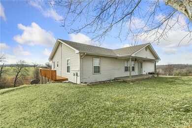 Front elevation. Wrap around deck. Views for miles from top of the hill.