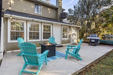 View of patio featuring a fire pit and grilling ar