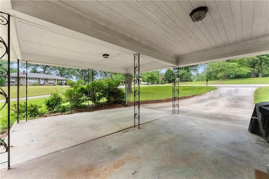 View of patio with a carport
