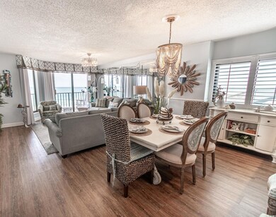 Dining room featuring a notable chandelier, a wate