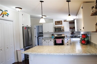 The kitchen features custom cabinets and counterto