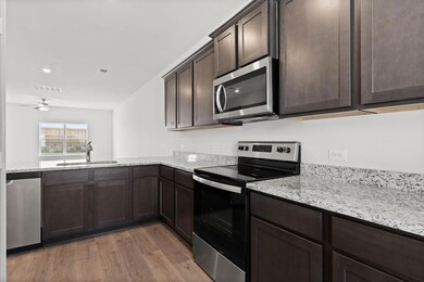 Kitchen with wood-style floors, sink, appliances w