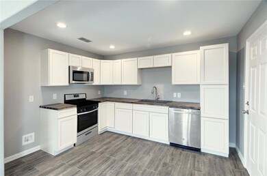 KITCHEN WITH BUTCHER BLOCK WOOD COUNTER TOPS AND S