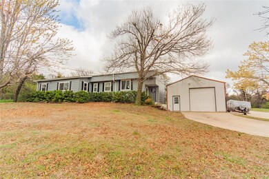 Ranch-style home featuring a front lawn