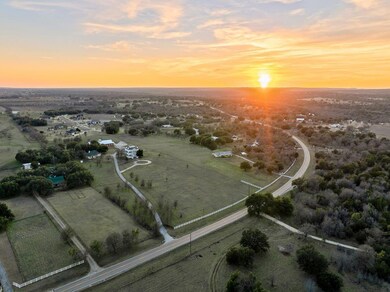 Aerial view at dusk featuring a rural view
