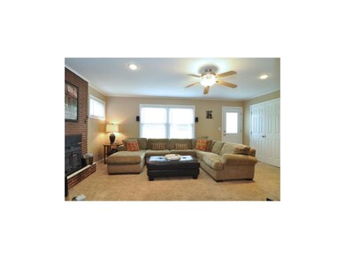 Huge family room features fireplace & ceiling fan