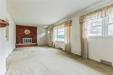 SPACIOUS LIVING ROOM with BRICK WOODBURNING FIREPL