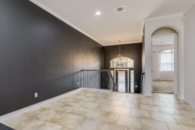 Entrance foyer with arched walkways, baseboards, 