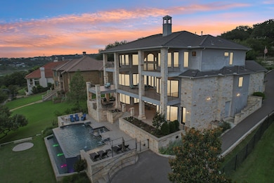 Back of house at dusk featuring a balcony, a pati
