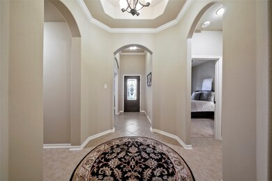 A grand entry with rotonda. Looking toward the front door, the en suite guest bedroom is on the right; the office on the left.