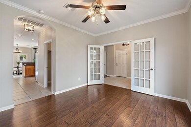 Spare room featuring crown molding, french doors,