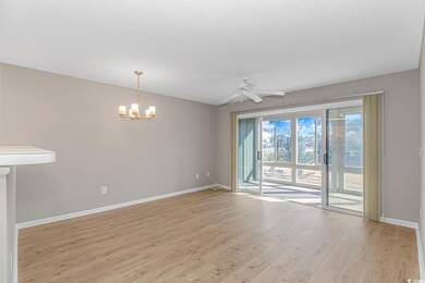 Spare room with ceiling fan with notable chandelie