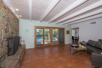 family room with rock fireplace Miraval