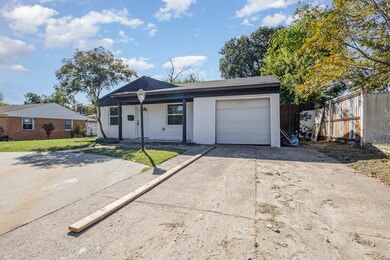 View of front facade featuring concrete driveway, an attached garage, and covered porch
