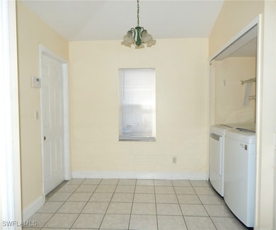 Unfurnished dining area featuring separate washer