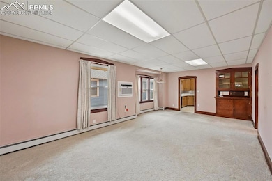 Spare room with a wall mounted AC, carpet floors, 
