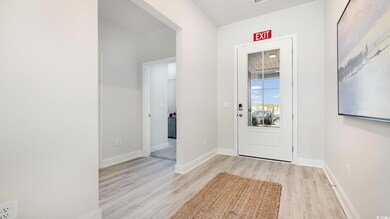 Foyer entrance featuring light hardwood / wood-sty