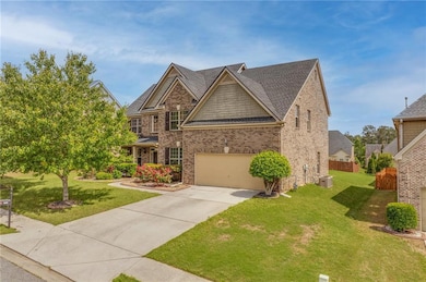 View of front of house with concrete driveway, bri