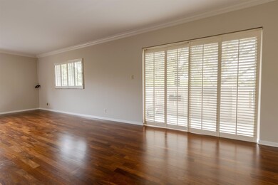 Spare room with ornamental molding and dark wood-t