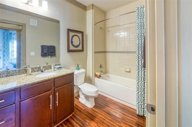 Full bathroom with vanity, toilet, wood-type floor
