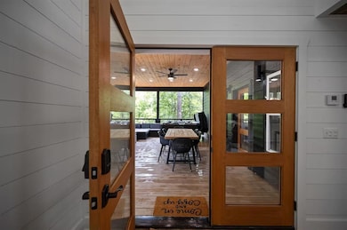 Doorway with hardwood / wood-style flooring, ceili