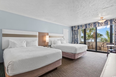 Bedroom featuring access to outside, a textured ceiling, carpet flooring, and crown molding