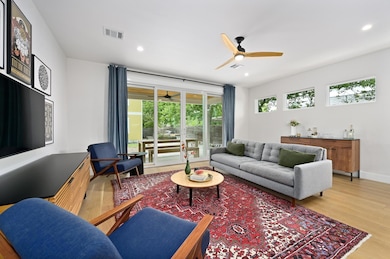 Living room featuring a ceiling fan, visible vent