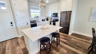 Open Concept Design Living with Stainless Appliances and Granite Counters