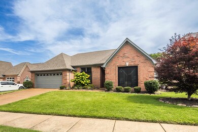 View of front of house featuring brick siding, a garage, a front lawn, roof with shingles, and driveway