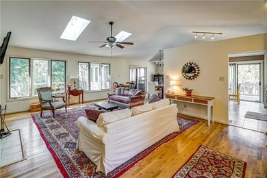 Spacious living area with hardwood floors, vaulted