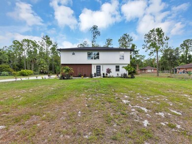 Rear view of property with a lawn