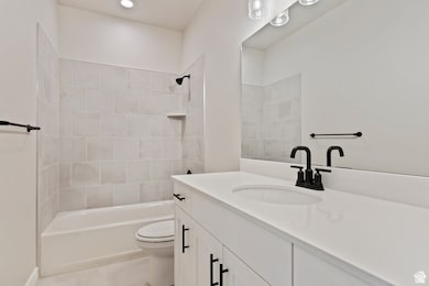 Bathroom with vanity, shower / bath combination, and recessed lighting