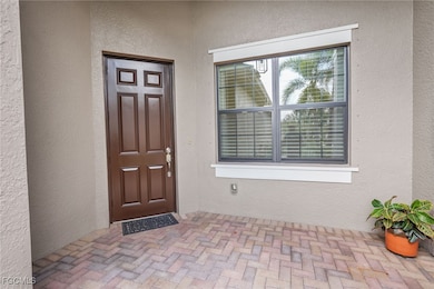 Property entrance featuring stucco siding