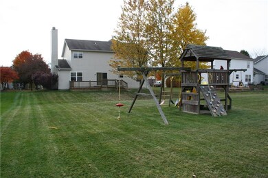 FULL VIEW OF THE BACK OF THE HOME,DECK AND PLAYSET.